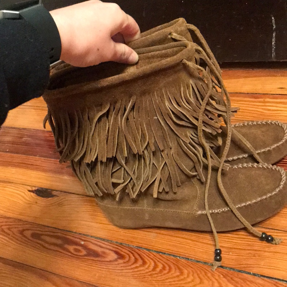 A pair of tall Minnetonka fringe boots size 7.5